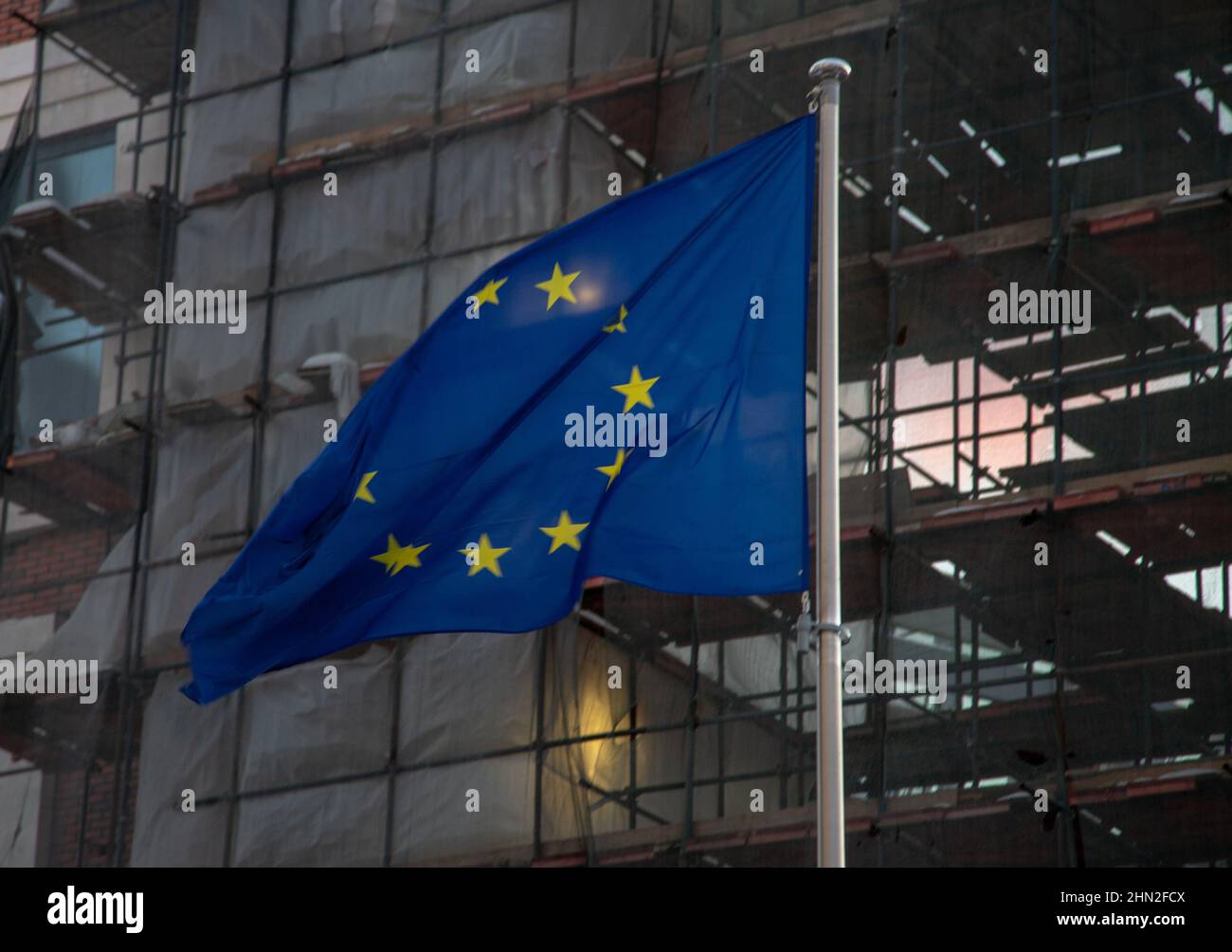 The flag of the European Union and the building under construction Stock Photo