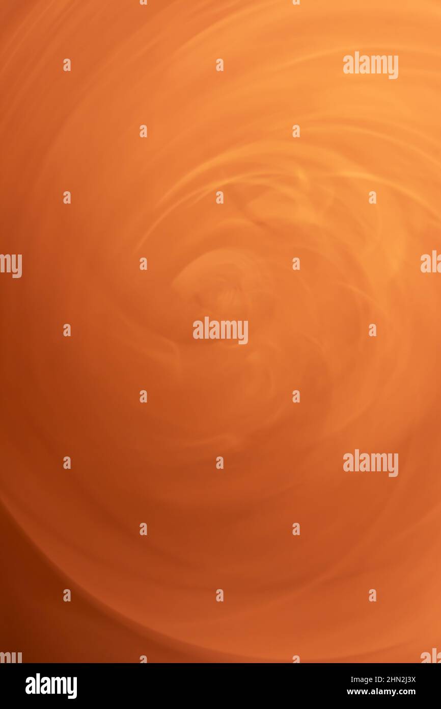 A whirlwind of orange sand. Vertical background abstraction. Backdrop Stock Photo