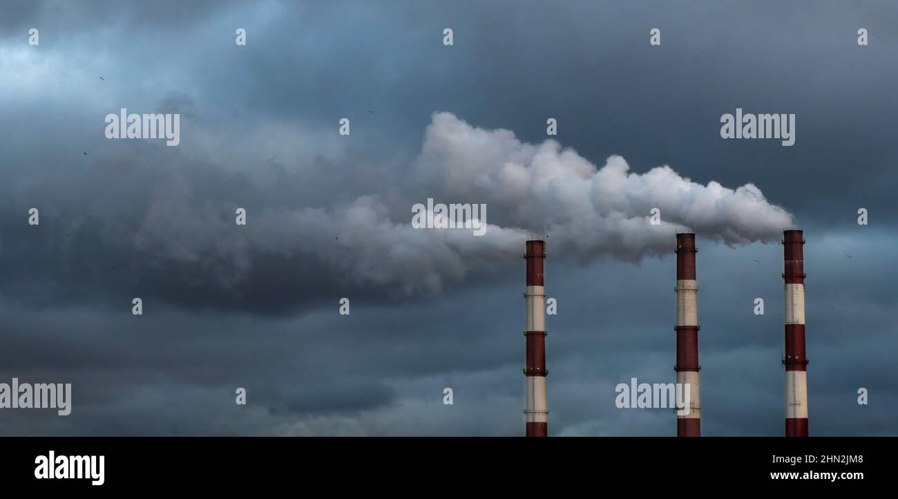 Three chimneys of CHP combined heat and power, factory smoke or fume Stock Photo