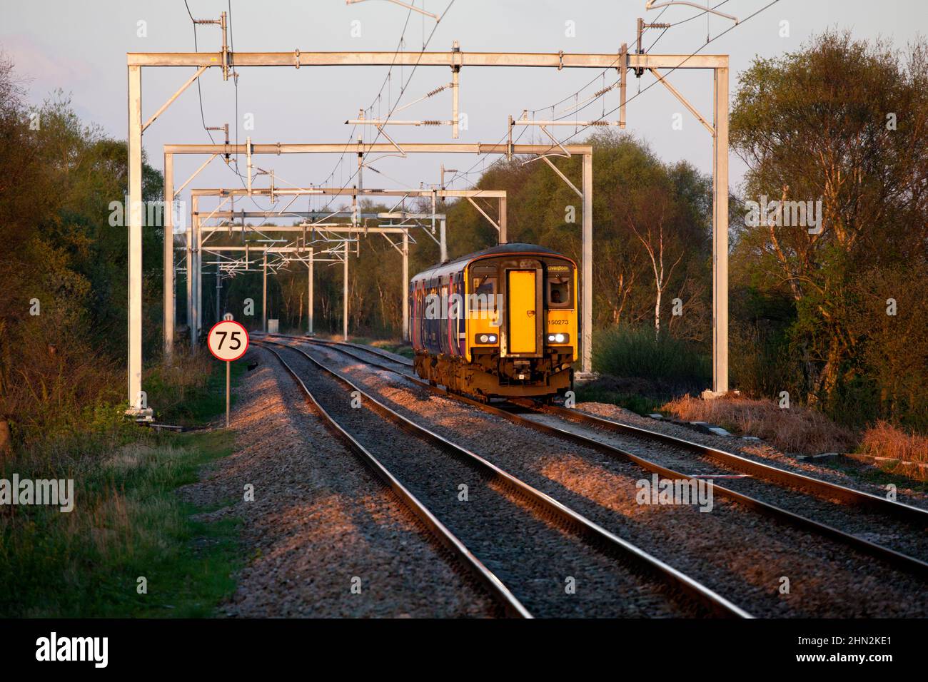Northern Rail class 150 sprinter train 150273 passing  Astley on the chat moss railway line, Lancashire, UK, showing subsidence in the track. Stock Photo