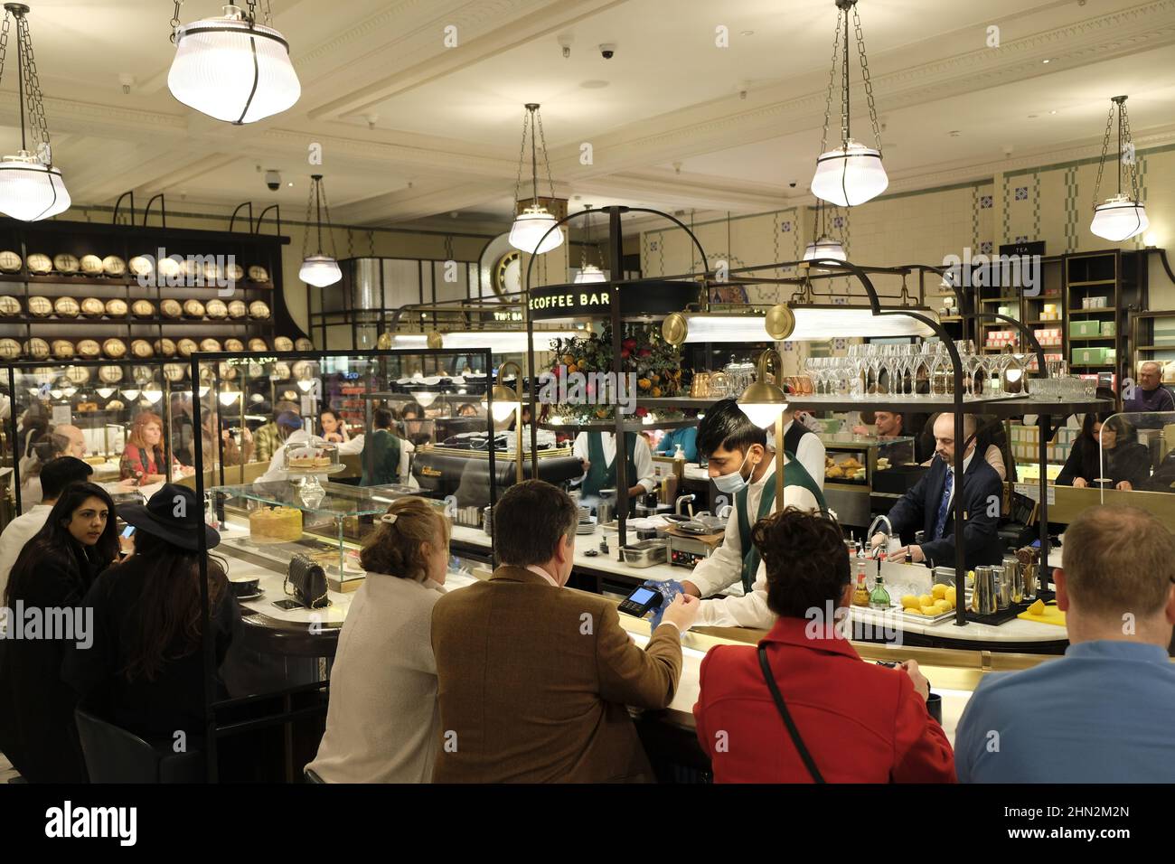London, UK - November 2021: Shoppers stop for a coffee at The Coffee Bar inside Harrods, London Stock Photo