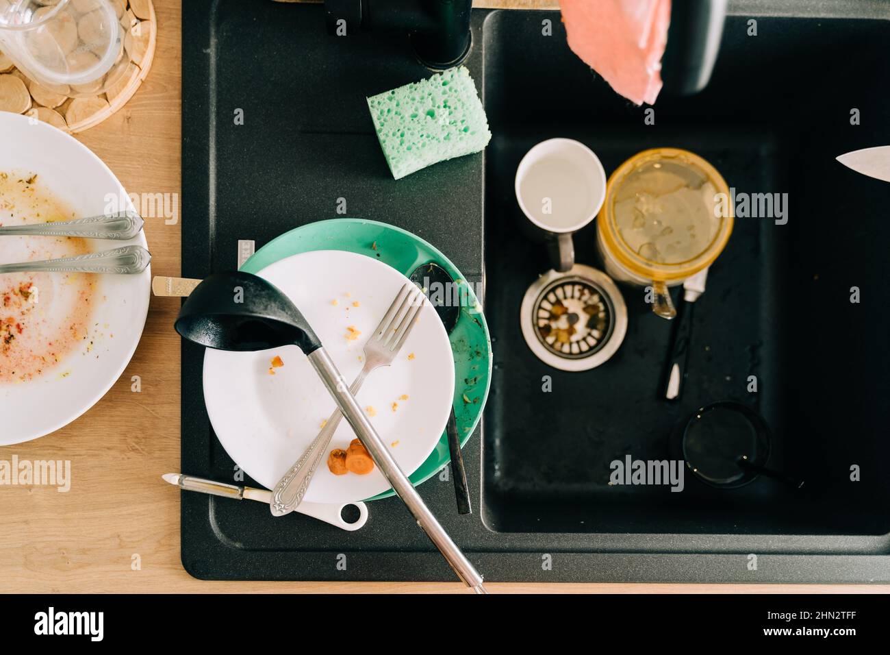 Wooden kitchen tabletop with black sink and dirty messy dish Stock ...