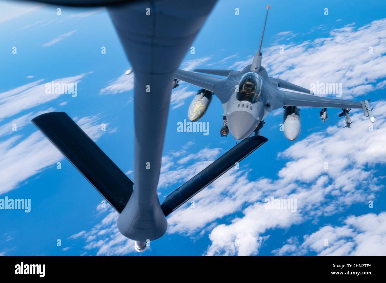 A U.S. Air Force  F-16 Fighting Falcon pilot assigned to the 14th Fighter Squadron conducts aerial refueling with a KC-135 Stratotanker aircraft assigned to the 909th Air Refueling Squadron during exercise Cope North 22 over the Pacific Ocean, Feb. 8, 2022. CN 22 allows each nation to hone vital readiness skills and enhance interoperability among multiple mission areas to include air superiority, interdiction, electronic warfare, tactical airlift, and aerial refueling capabilities. (U.S. Air Force photo by Master Sgt. Joey Swafford) Stock Photo