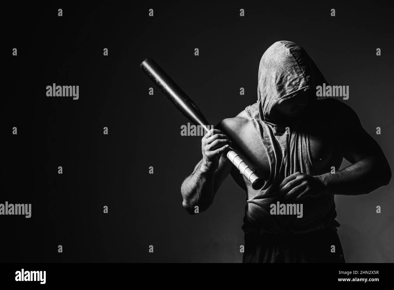 Dangerous man in the mask with baseball bat ready for fight. An