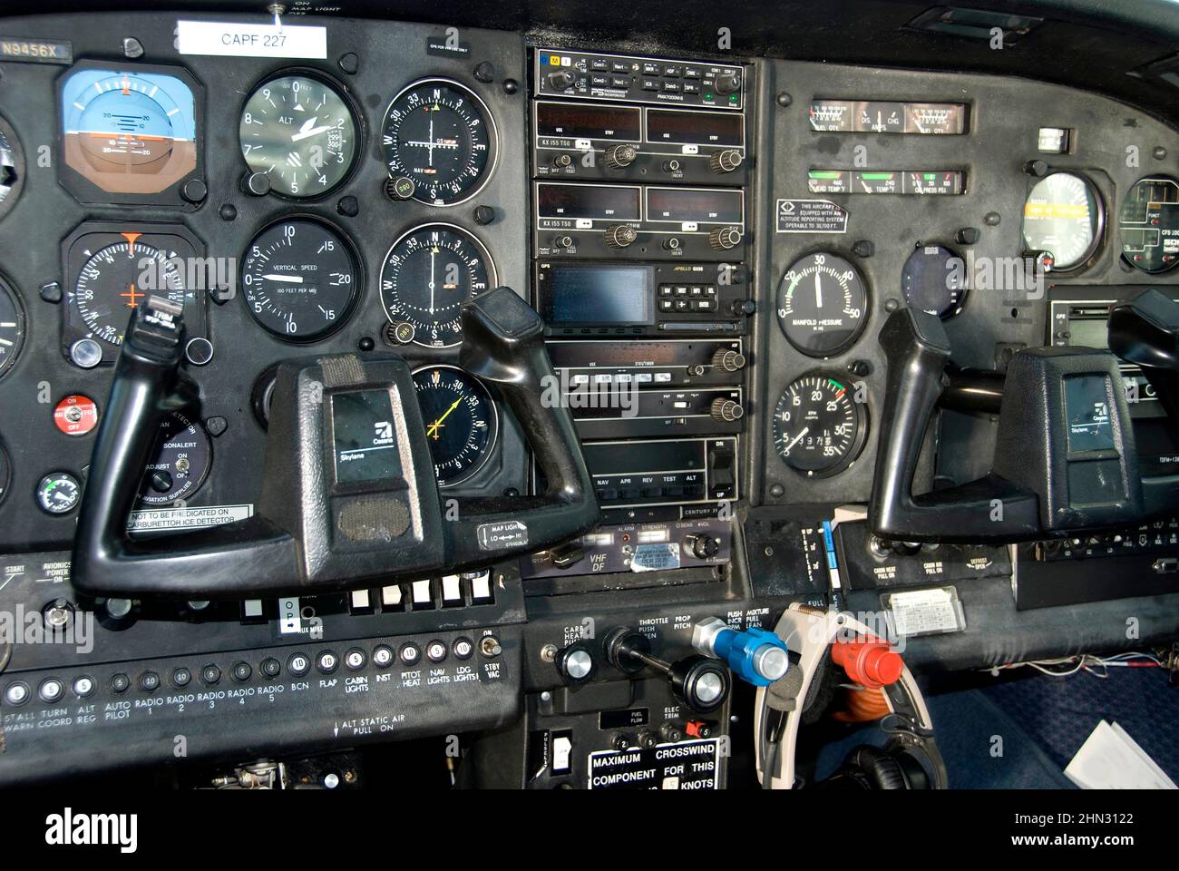dashboard of an aircraft control panel showing all of the navigation gages, dials and other radio connectivity instruments Stock Photo