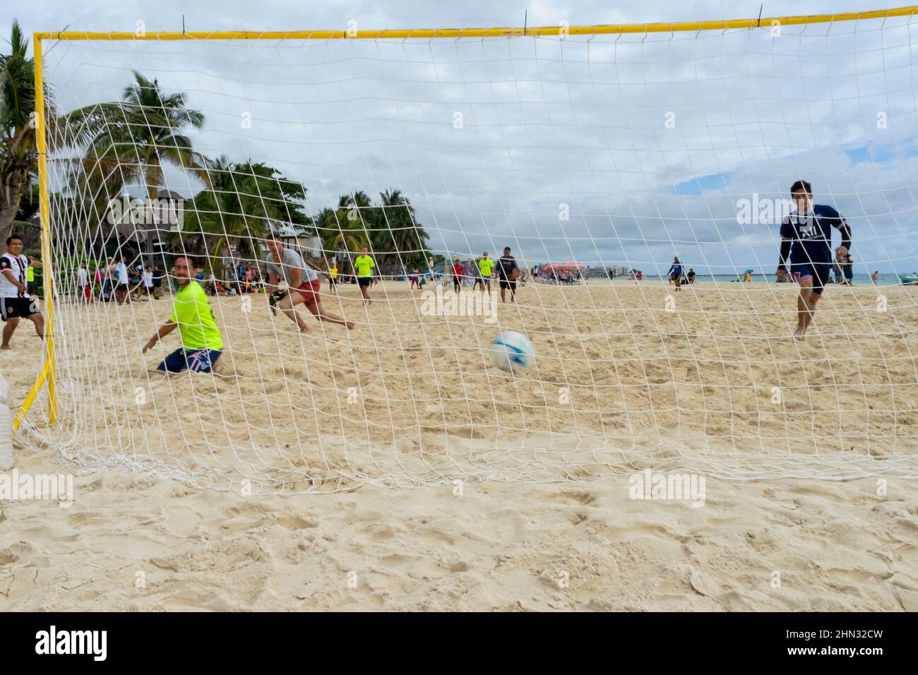 A soccer match on the beach in front of the Caribbean Sea in Playa del Carmen, Mexico. Goal. Stock Photo