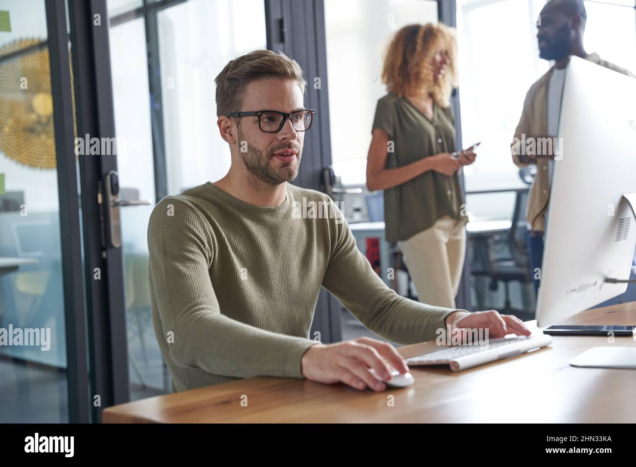 Serious man speaking with customer via internet Stock Photo