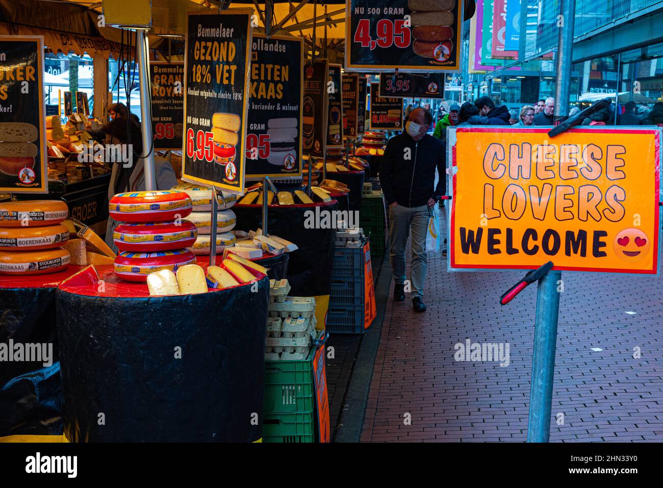 People shopping at a cheese stall on a market in Haarlem Schalkwijk The Netherlands on 19 January 2022 Stock Photo