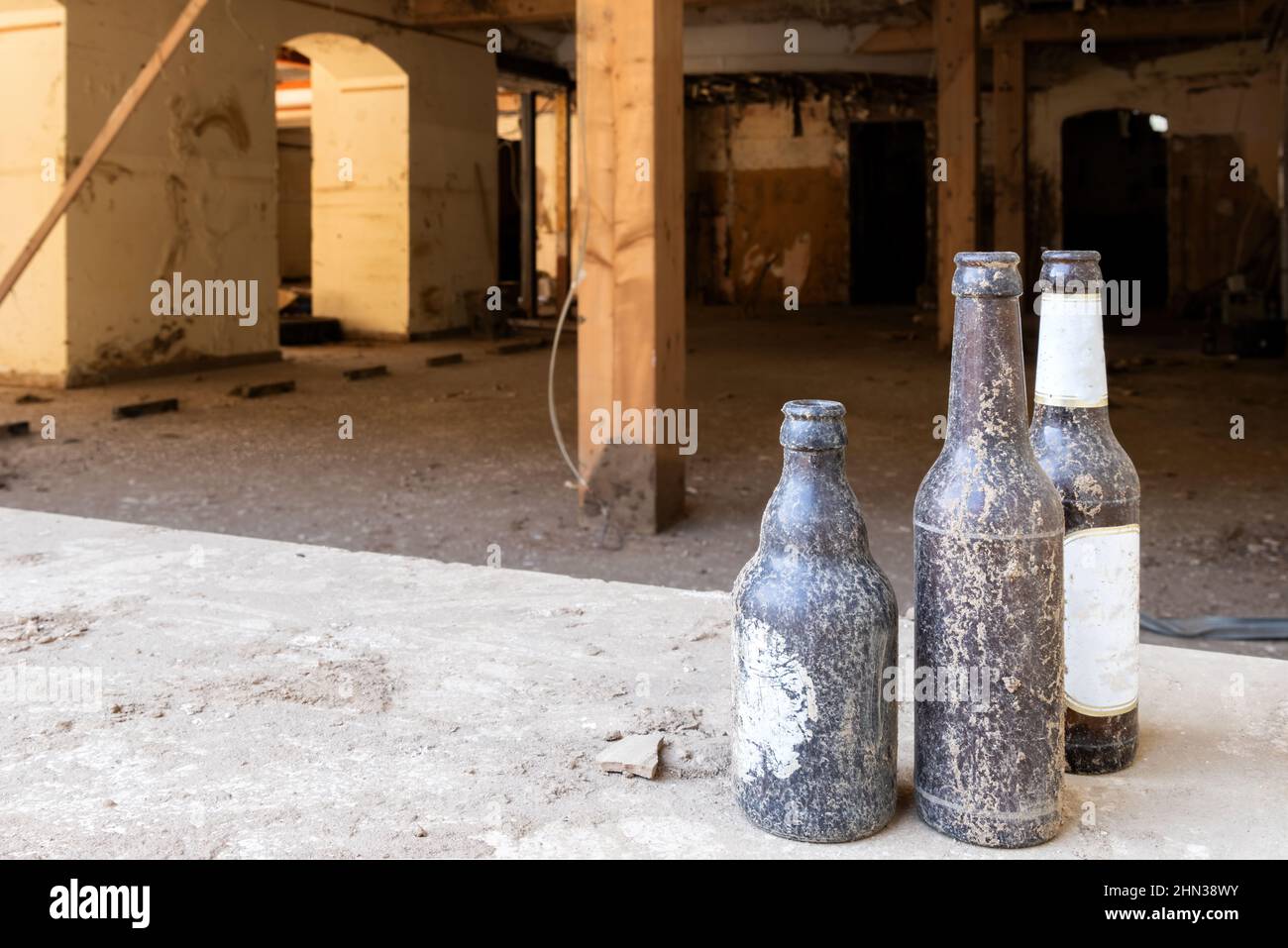 Muddy beer bottles from the Ahr valley with blurred background. Flood damage in Ahrtal and Eifel. Reconstruction after cleanup. Stock Photo