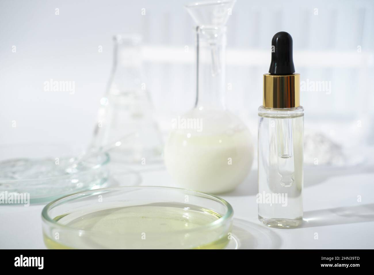 laboratory dishes and glassware on a lab table. fermentation, fermented beauty skin care. dropper bottle of solution or serum for anti age treatment Stock Photo