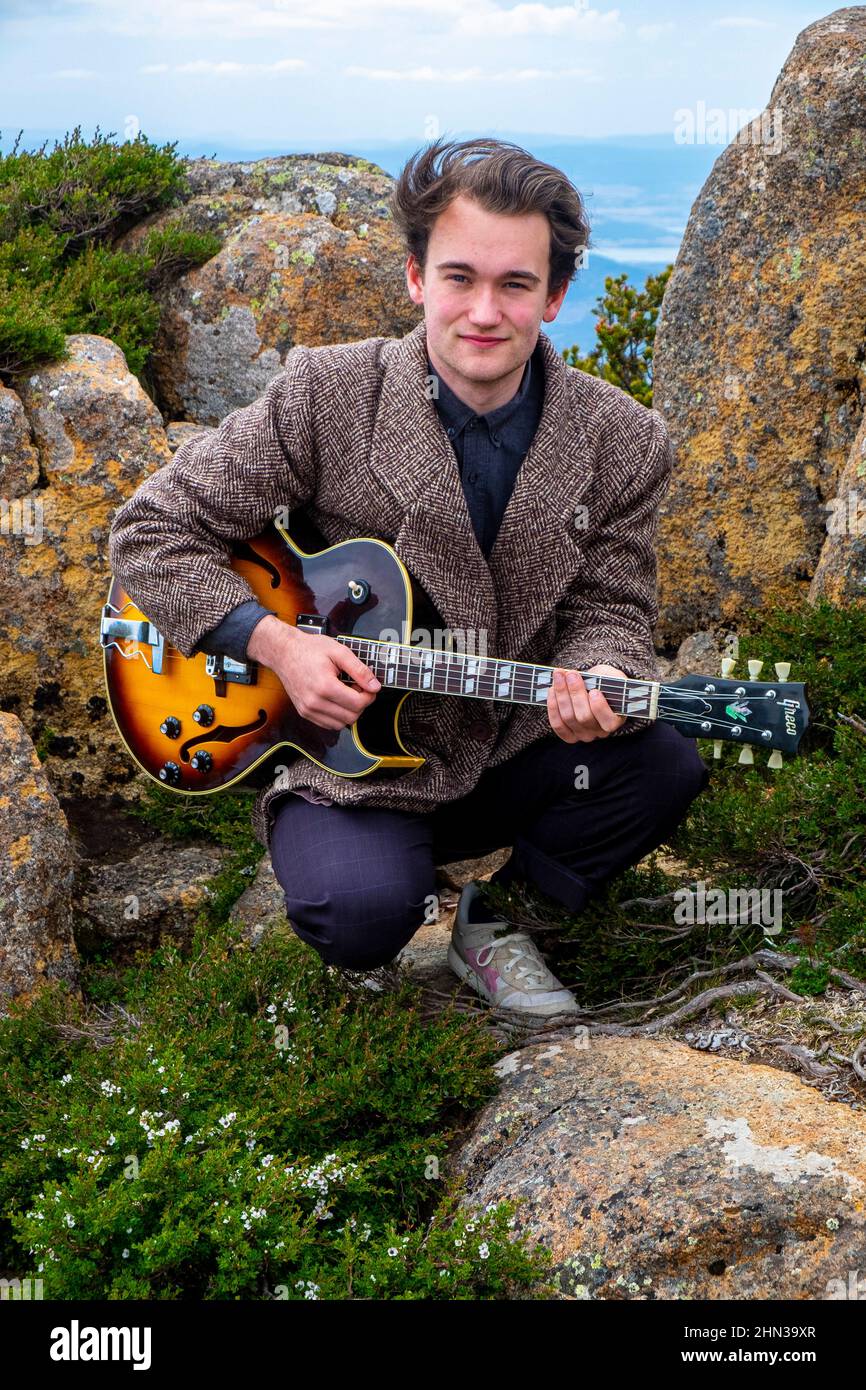 Young Tasmanian teenage jazz musician and guitarist Eli Davies photographed on the summit of Mount Wellington in Hobart Stock Photo