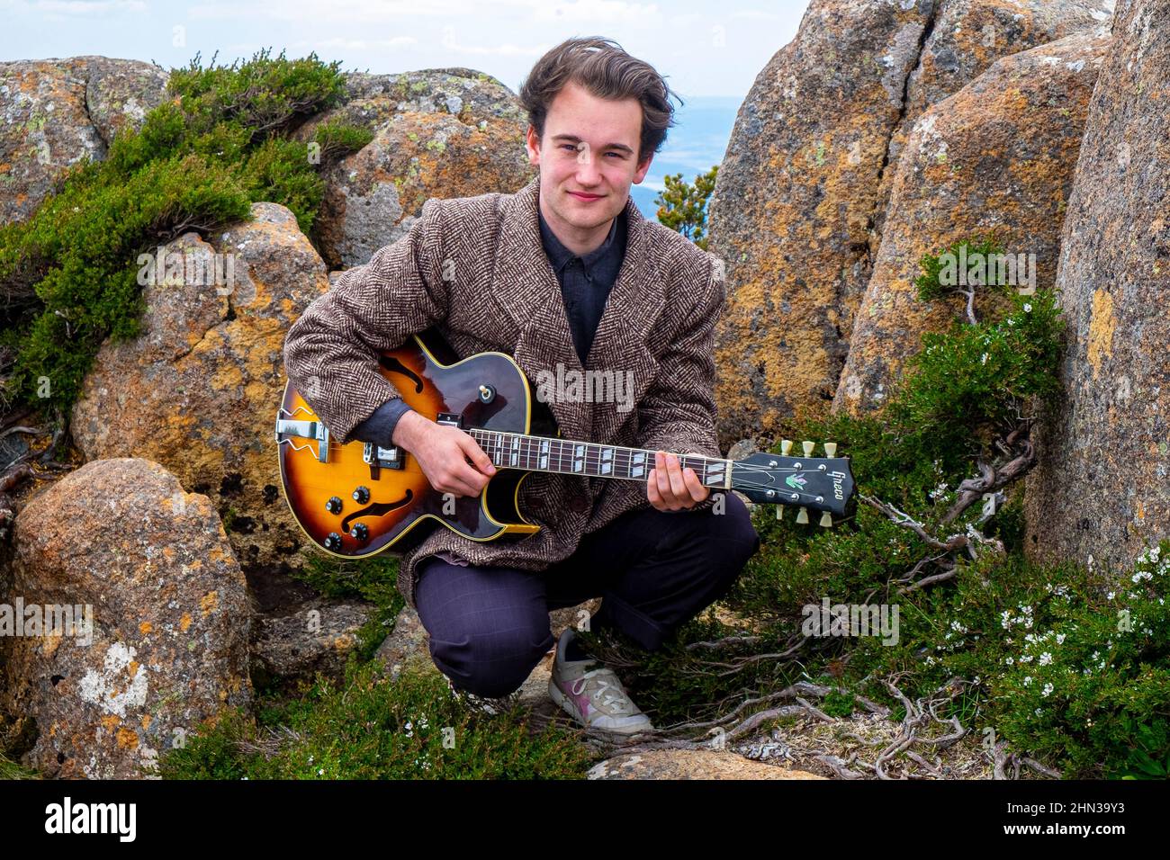 Young Tasmanian teenage jazz musician and guitarist Eli Davies photographed on the summit of Mount Wellington in Hobart Stock Photo