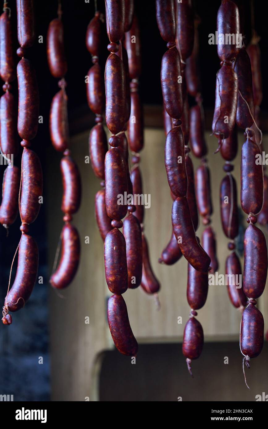 Freshly made sausages with pork and drying hanged with wood smoke and air. Stock Photo