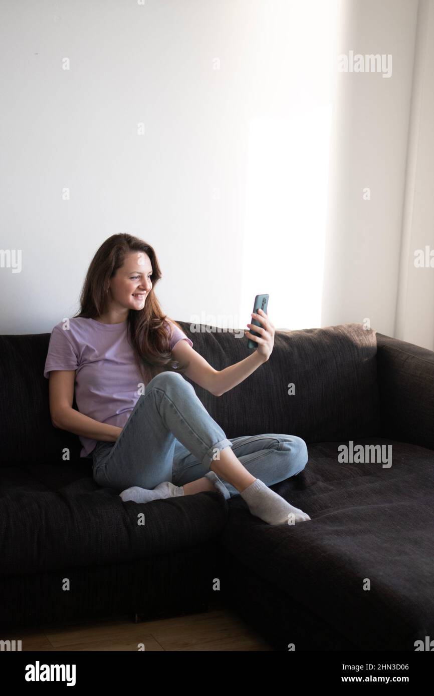 One adult woman sofa talking hi-res stock photography and images - Alamy