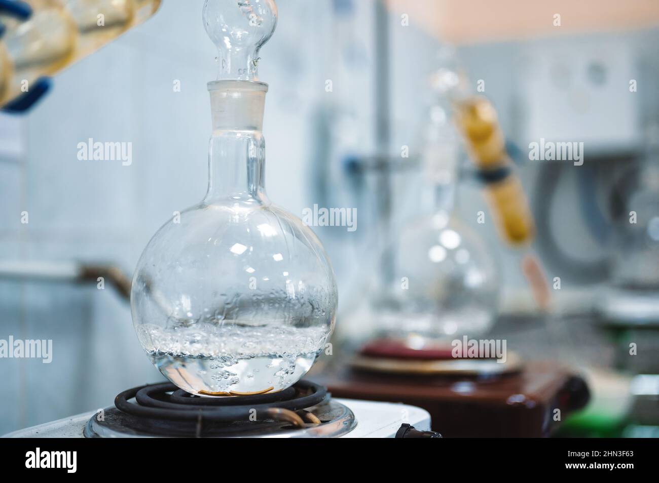 Flask with boiling alcohol at distillation in laboratory Stock Photo