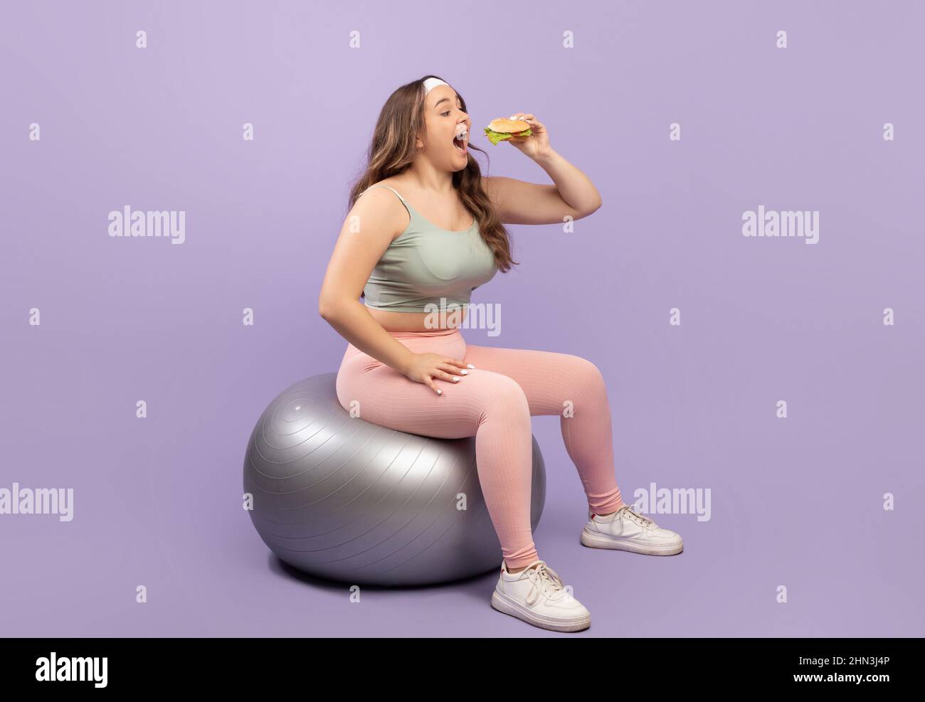 a fat girl stretching in a gym outfit Stock Photo - Alamy