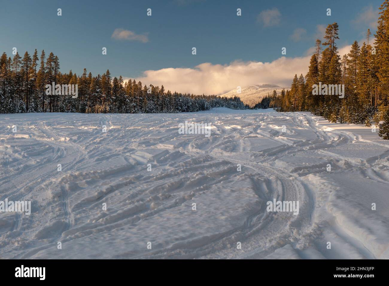 The runway of Oregon's Crescent Lake State Airport (5S2) becomes a snowmobile play area in winter. Stock Photo