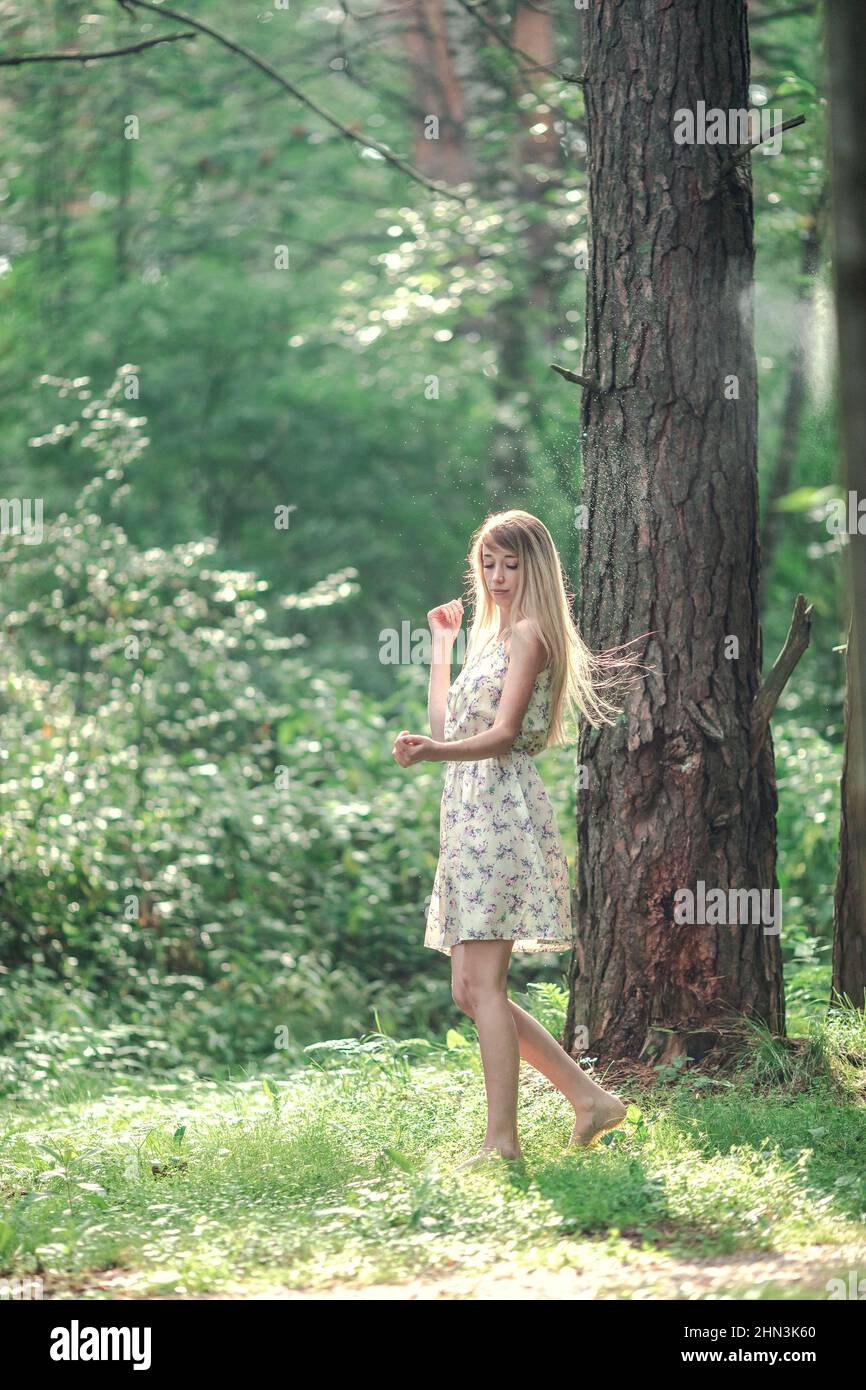 Blonde girl in a light airy dress 