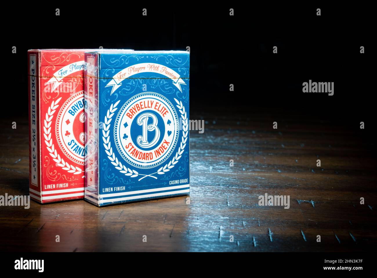 SAINT CLOUD, MINNESOTA - 11 FEBRUARY, 2022: Two packs of Brybelly Elite playing cards sit on a wooden table. Stock Photo