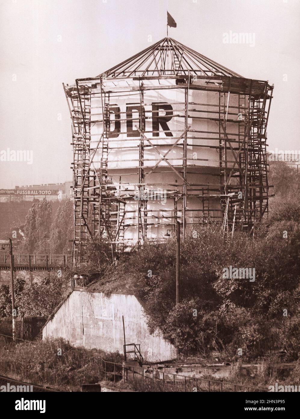 Vintage photo of Berlin Crisis of 1961: Building the Wall The DDR Sign Is Sported on a Water Tower at the Train Tracks at Gesundbrunnen. October, 24, Stock Photo