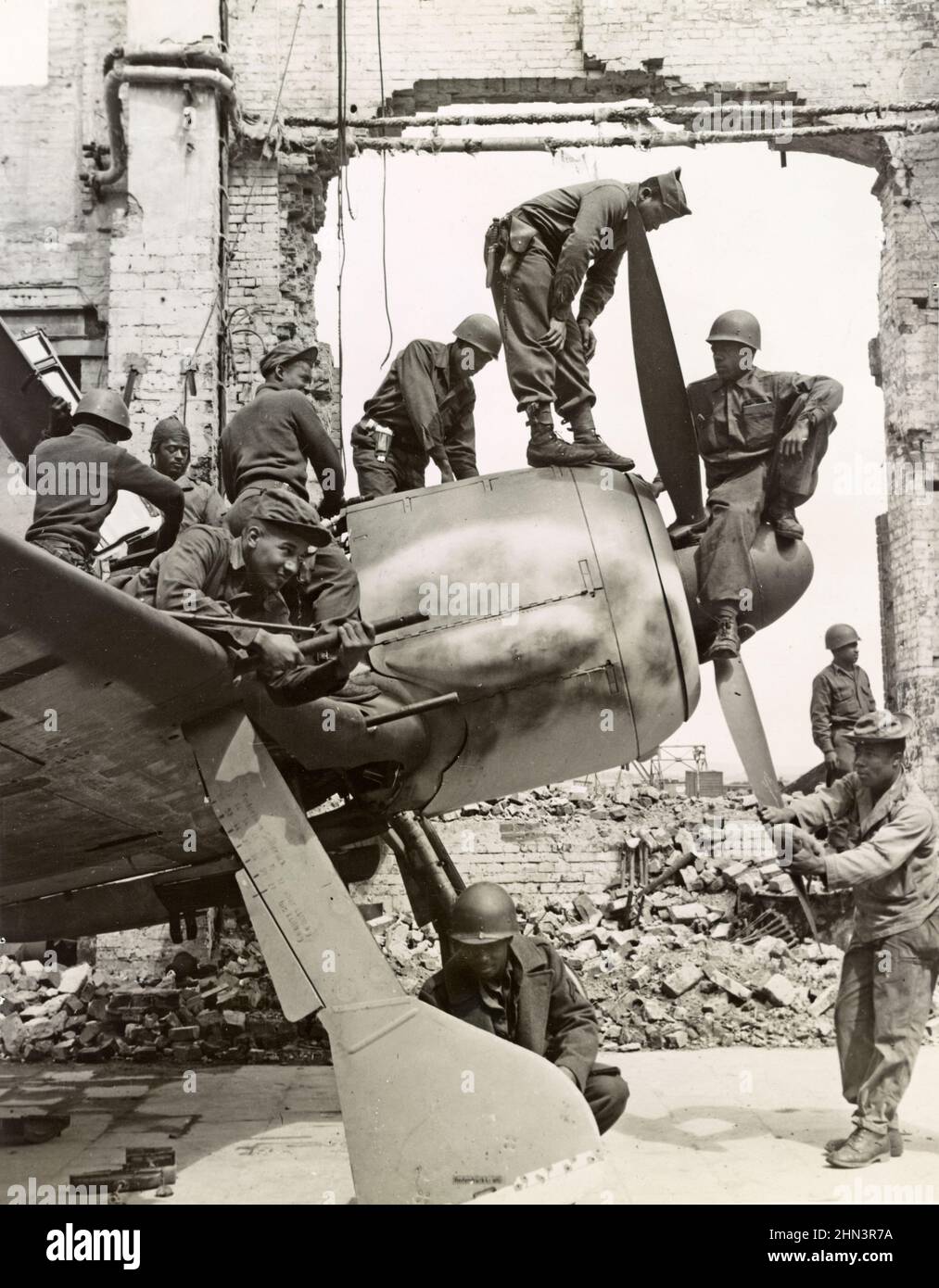 African American soldiers of 4046th Quartermaster Truck Co. found AGO Fluzeugwerke A.G. at Oschersleben a source of souvenirs. Germany. 1945 Stock Photo