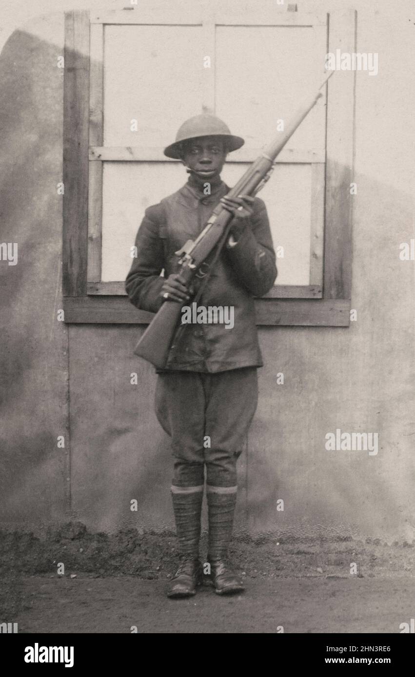 USA in World War I. African American soldier in uniform and helmet with rifle. 1917-1918 Stock Photo
