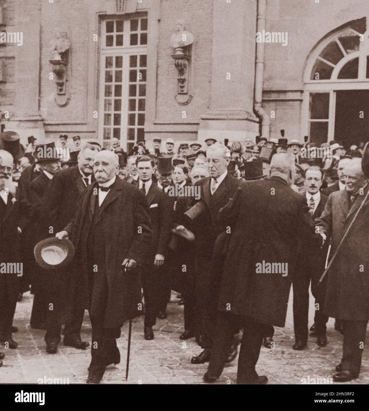 Vintage photo of M. Clemenceau, Woodrow Wilson and Lloyd George leaving Palace of Versailles after signing peace treaty. France. 1919 Stock Photo
