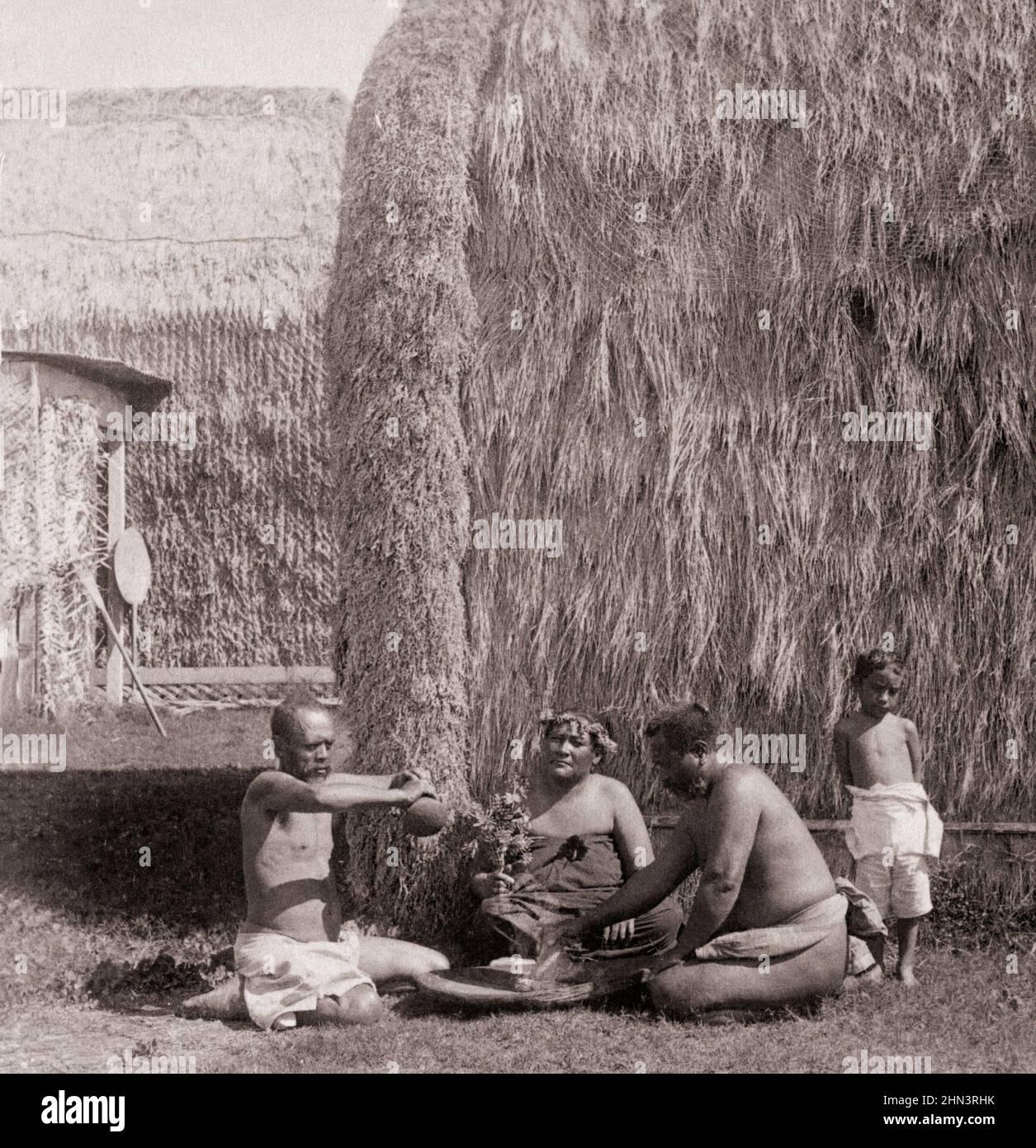 Vintage photo of group of Native Kanaka Maoli eating poi, Hawaiian Islands (in front of grass hut). 1896 Native Hawaiians are the Indigenous Polynesia Stock Photo