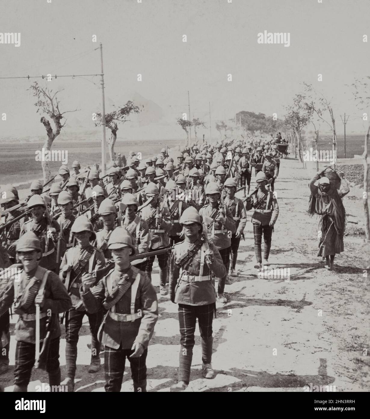 Vintage photo of brigade of Highland Troops on road before the pyramids Cairo, Egypt. 1903 Stock Photo