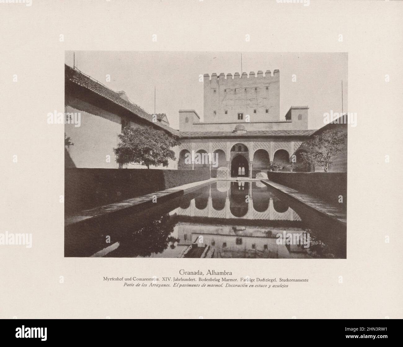 Vintage photo of Alhambra. Court of the Myrtles and Comares Tower. XIV century. Marble flooring. Colored roof tiles. Stucco ornaments. Granada, Andalu Stock Photo