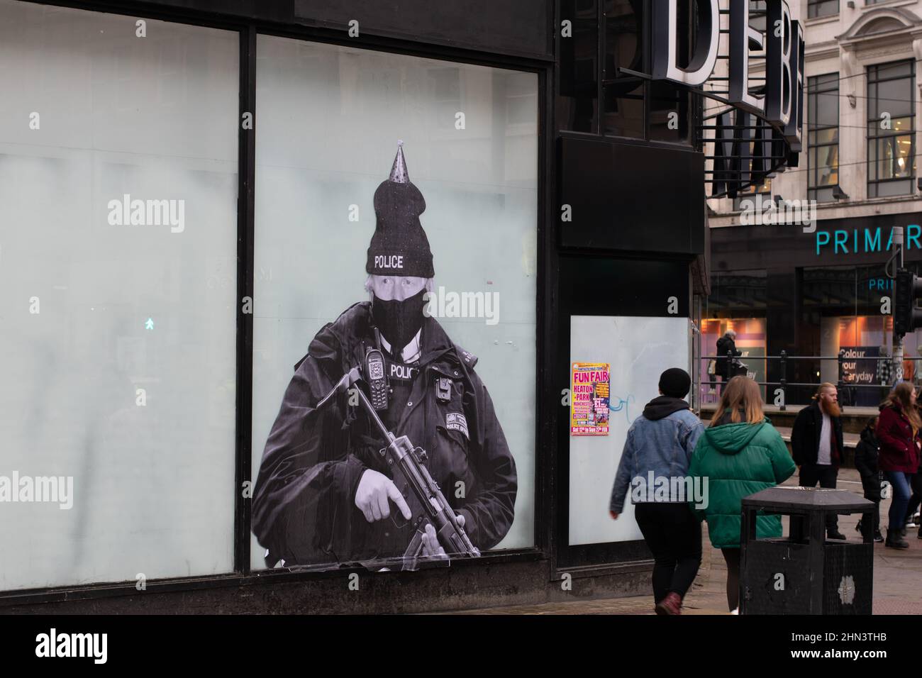 Boris Johnson dressed as a Metropolitan Police officer. Poster on window of former Debenhams department store, Market Street, Manchester. Stock Photo