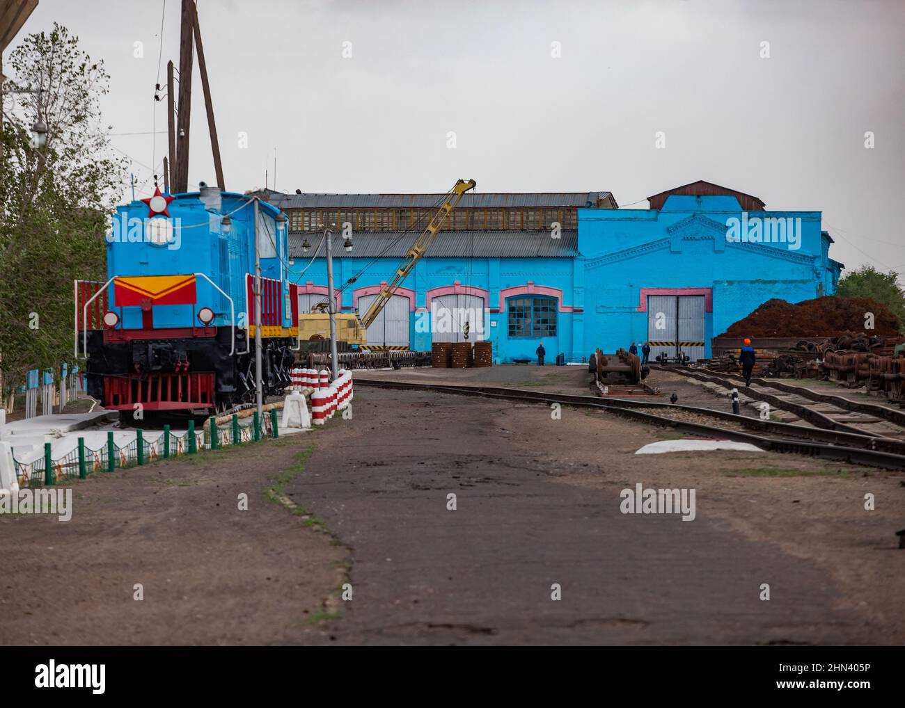 Locomotive repair plant . Soviet diesel loco left. Vintage depot building. Stock Photo