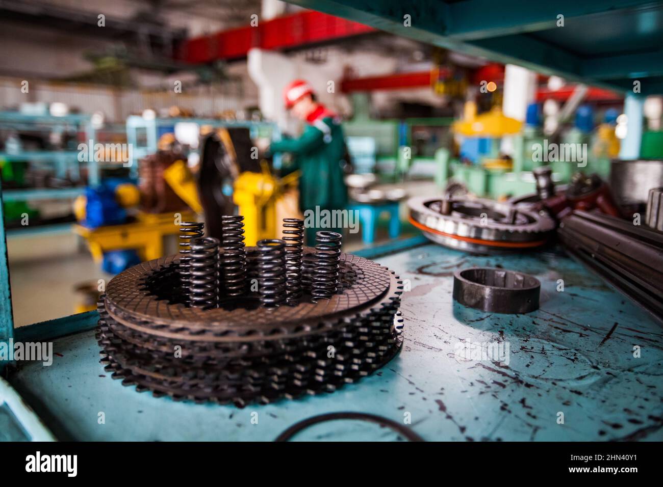 Close up photo of metal transmission parts with spring on cracked metal ...