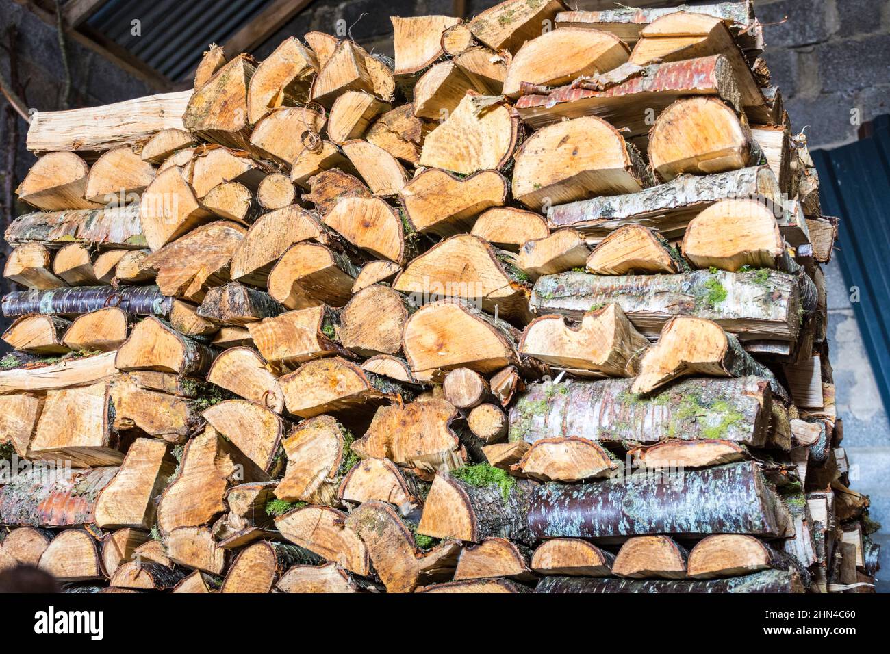 Woodpile. Logs cut for fuel in wood burning stove. County Donegal, Ireland Stock Photo