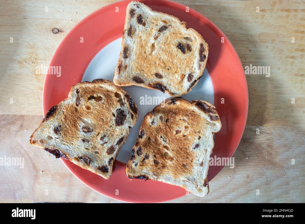 Toasted fruit loaf on a plate is comfort food eaten for breakfast or as tasty snack. Stock Photo
