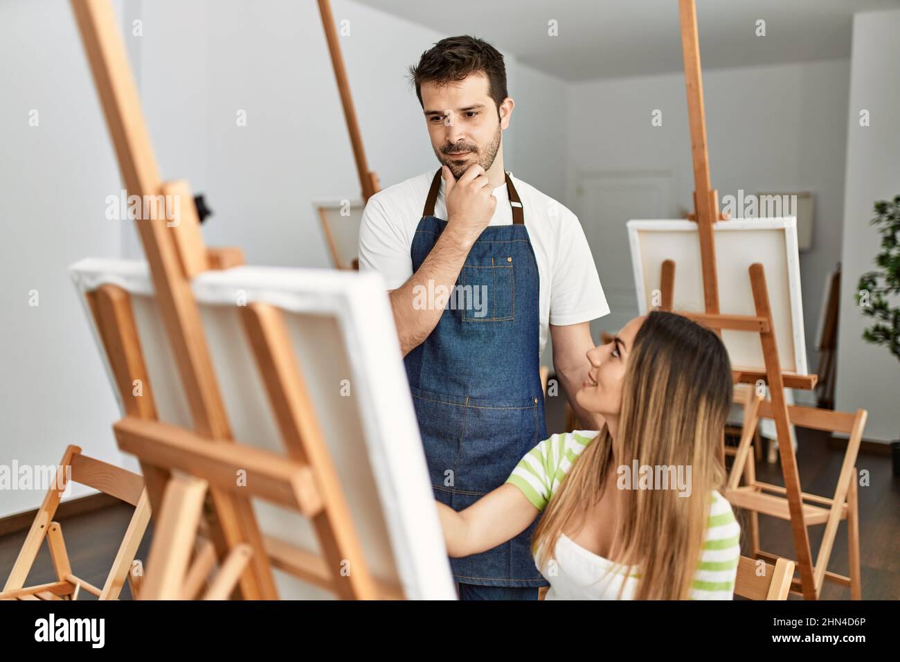 Student and teacher smiling happy painting at art studio Stock Photo ...