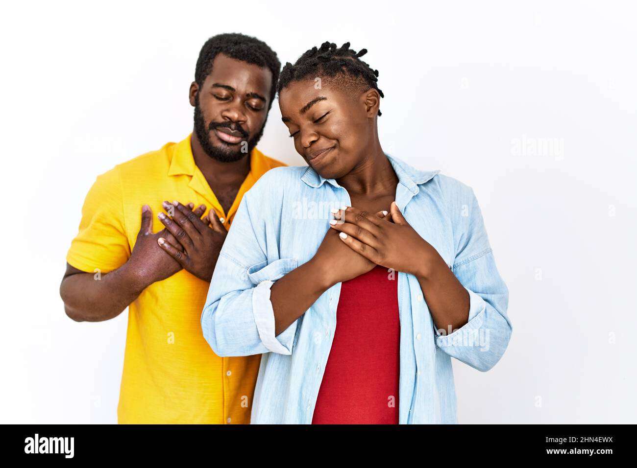 Young african american couple wearing casual clothes smiling with hands ...