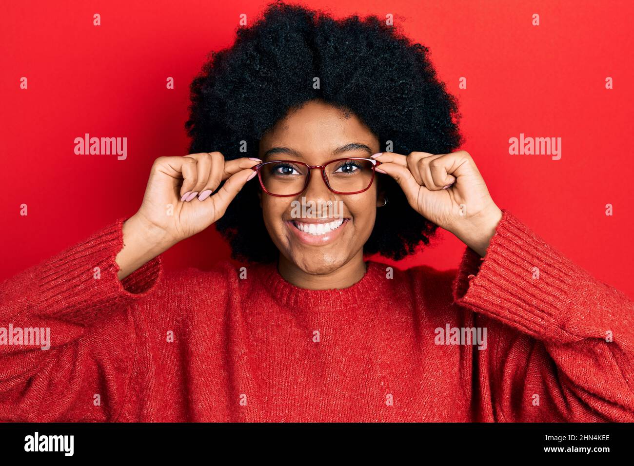 Young african american woman wearing glasses smiling with a happy and ...