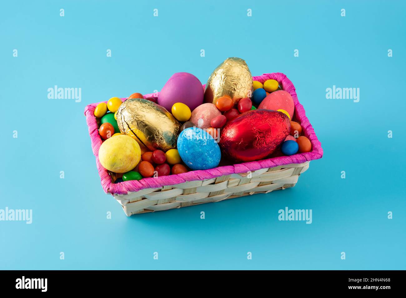 Colorful chocolate Easter eggs on blue background Stock Photo