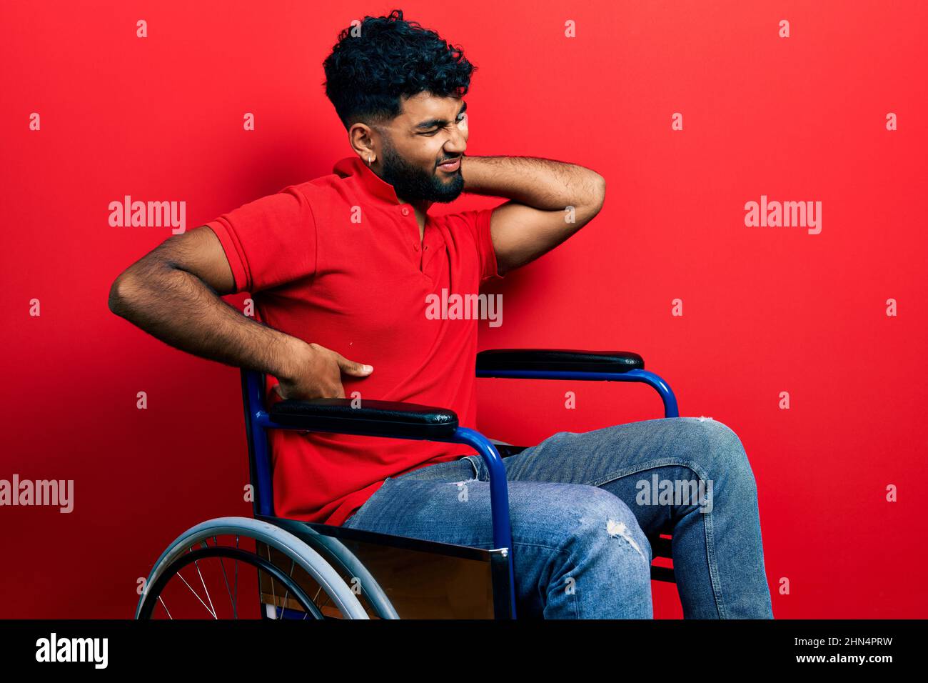 Arab man with beard sitting on wheelchair suffering of neck ache injury