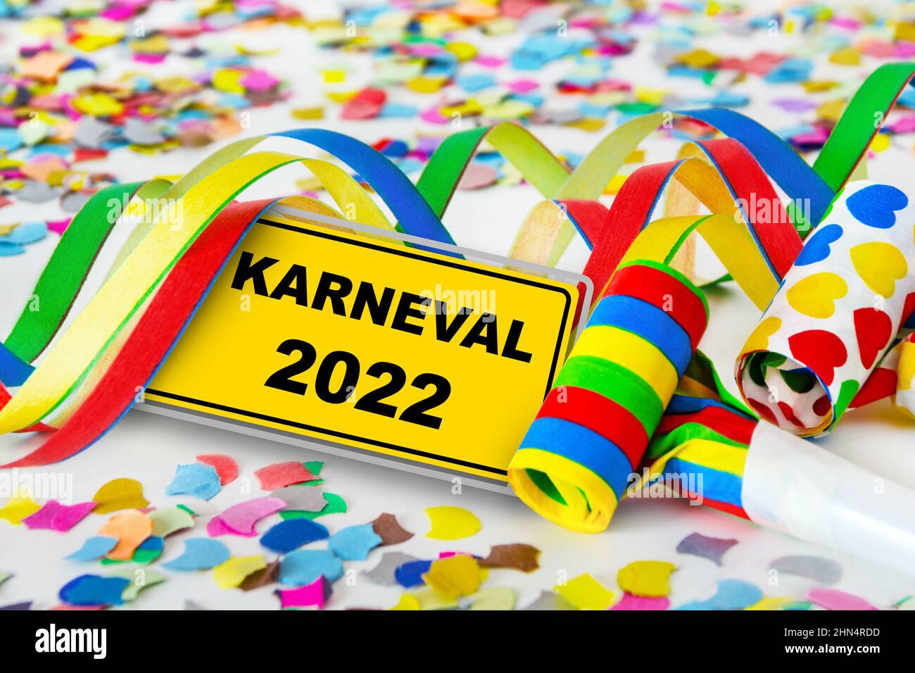 Yellow sign and German Carnival 2022 with party decorations Stock Photo