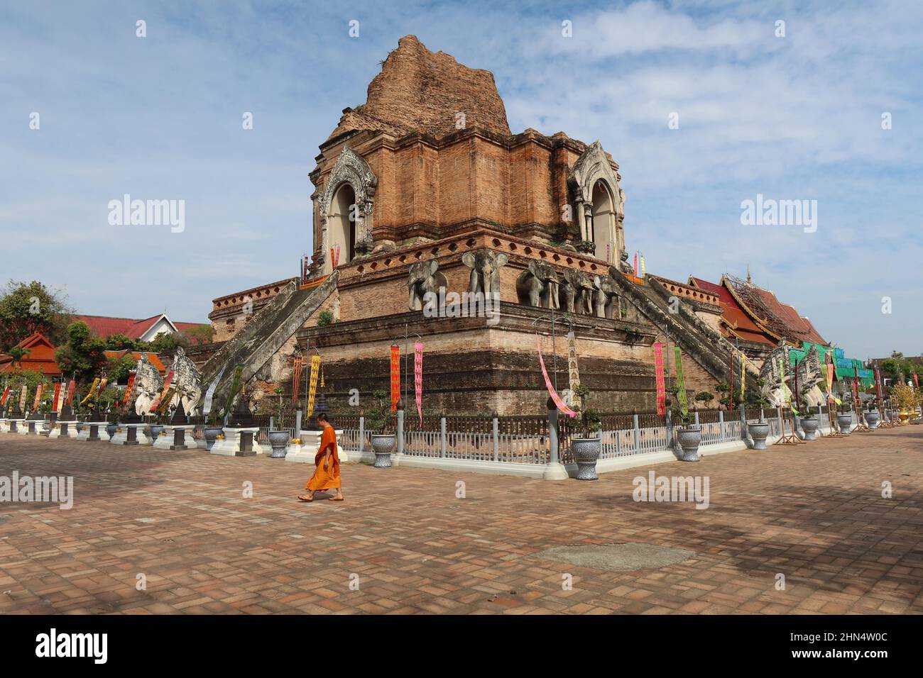 Monk walking in front of Wat Chedi Luang, Chiang Mai, Thailand Stock Photo