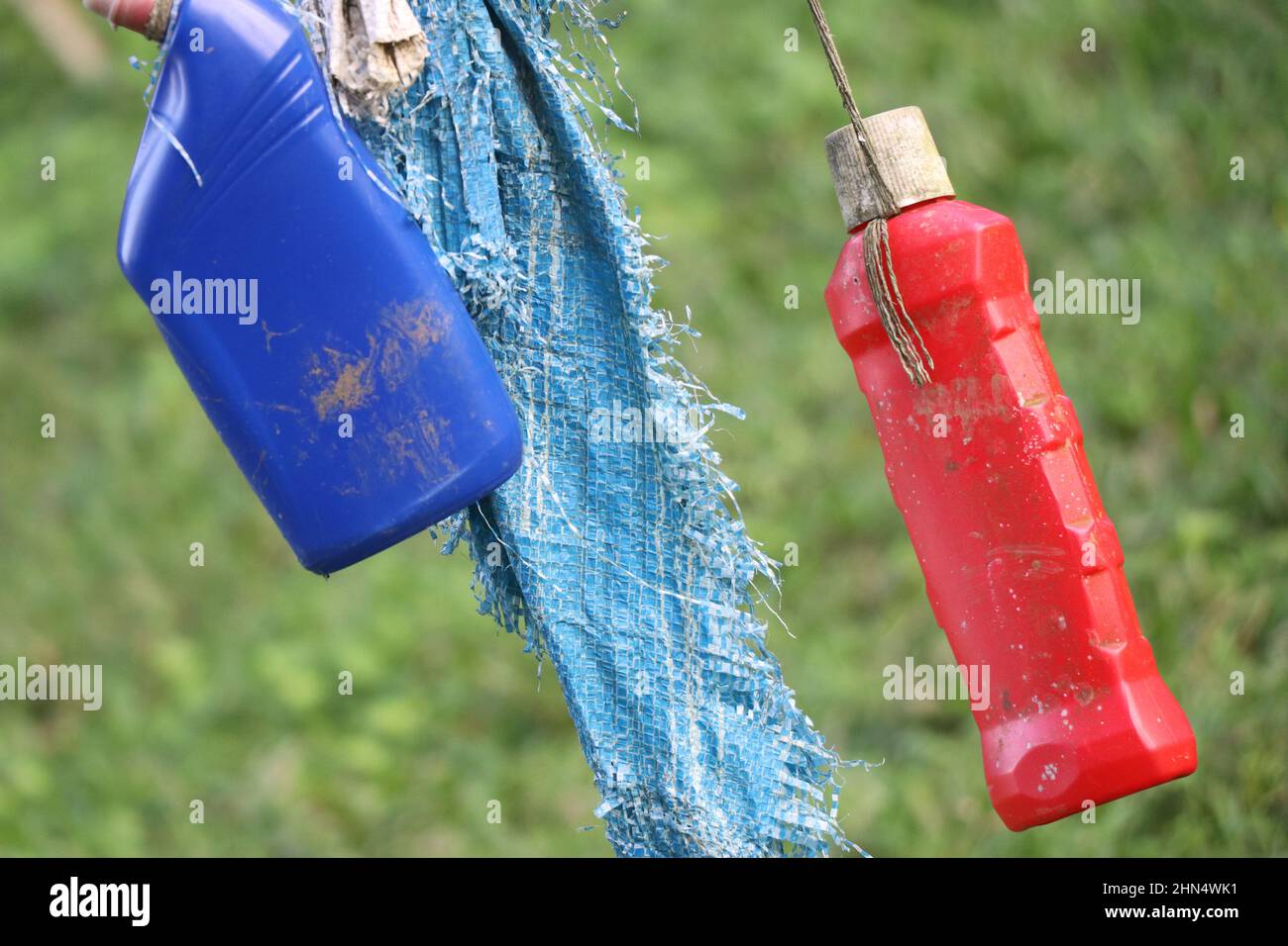 Empty and waste plastic bottles hanging on the rope Stock Photo