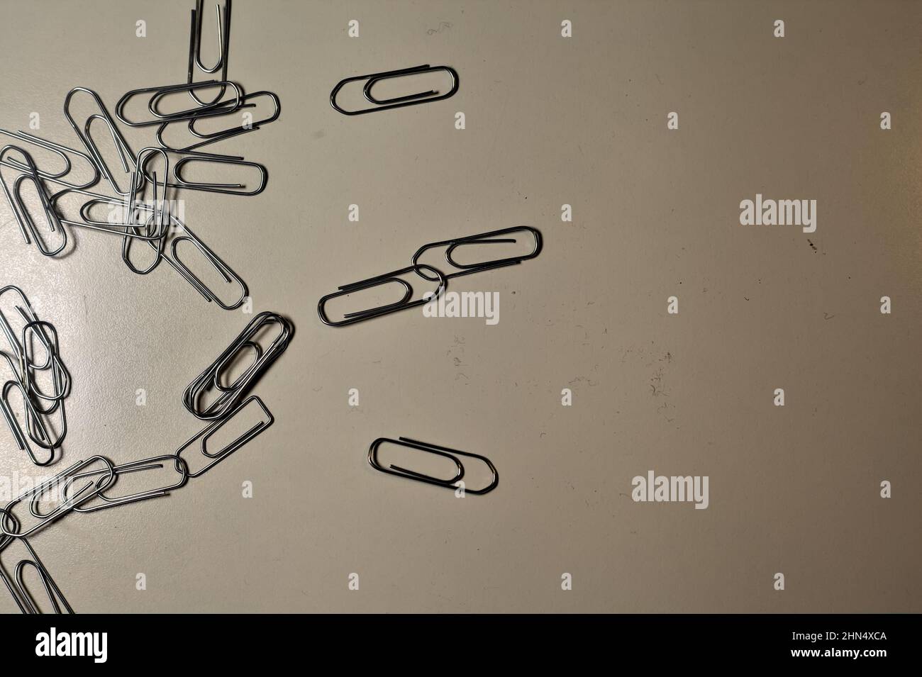 Clips scattered on a desk Stock Photo - Alamy