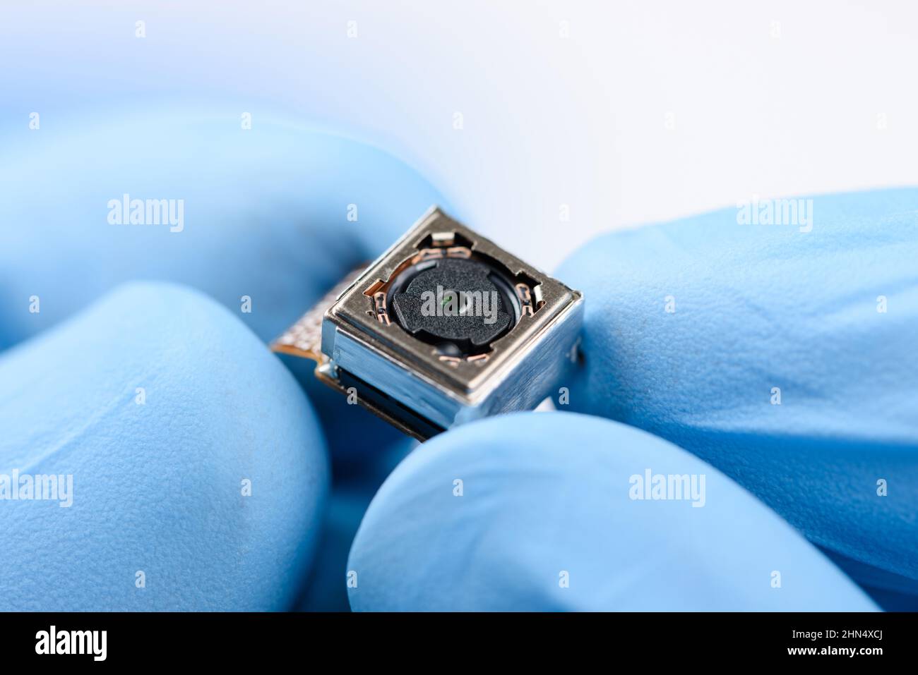 Cell phone single camera module in scientist hands Stock Photo