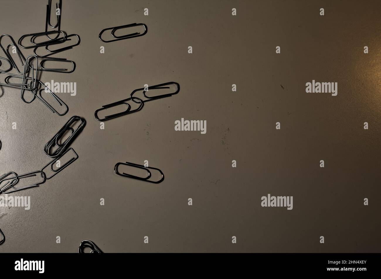 Clips scattered on a desk Stock Photo - Alamy