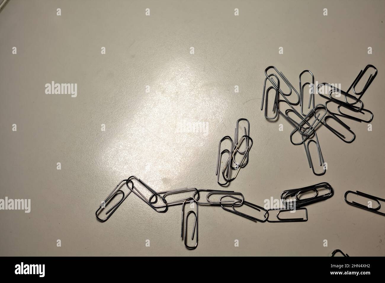 Clips scattered on a desk Stock Photo - Alamy