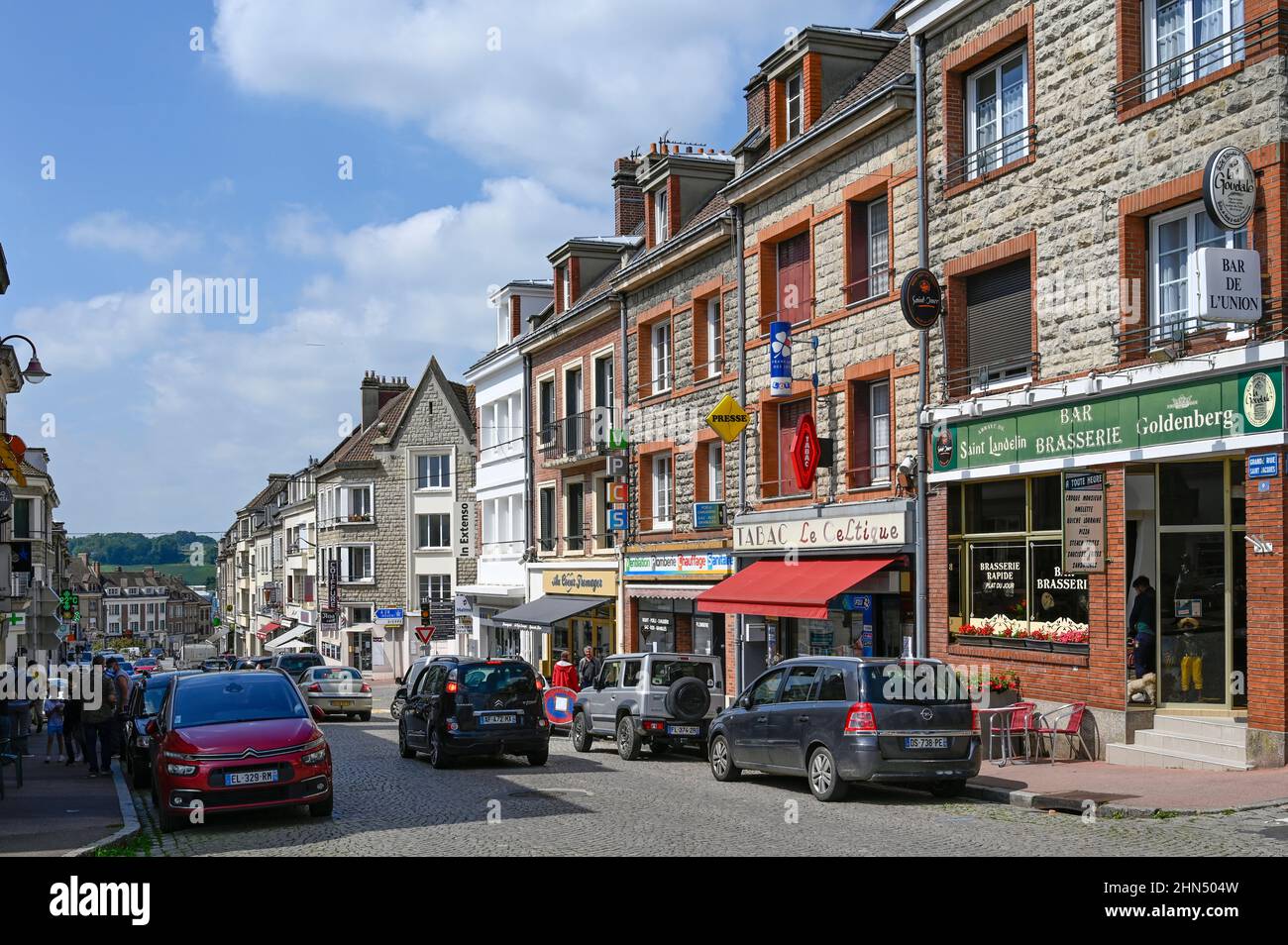 Shops border the main road (D928) in the centre of Neufchâtel-en-Bray, Normandy, France Stock Photo