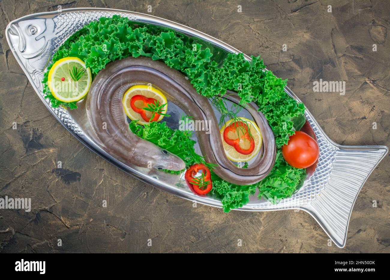 uncooked row conger fish with vegetables Stock Photo