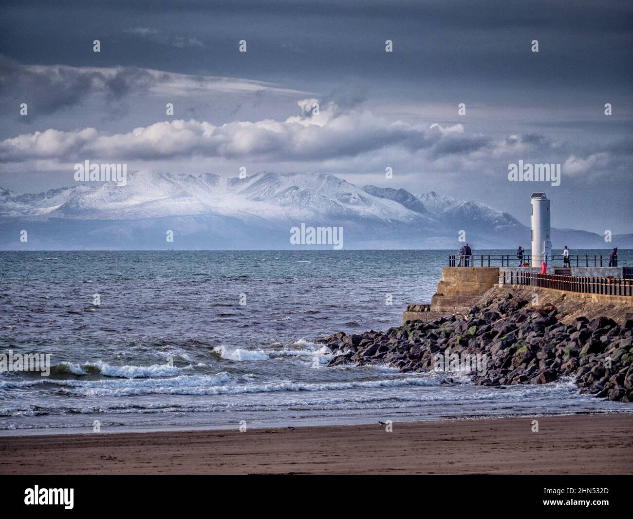 Winter view looking towards Isle of Arran sonw capped peaks from the beach at Ayr. Stock Photo